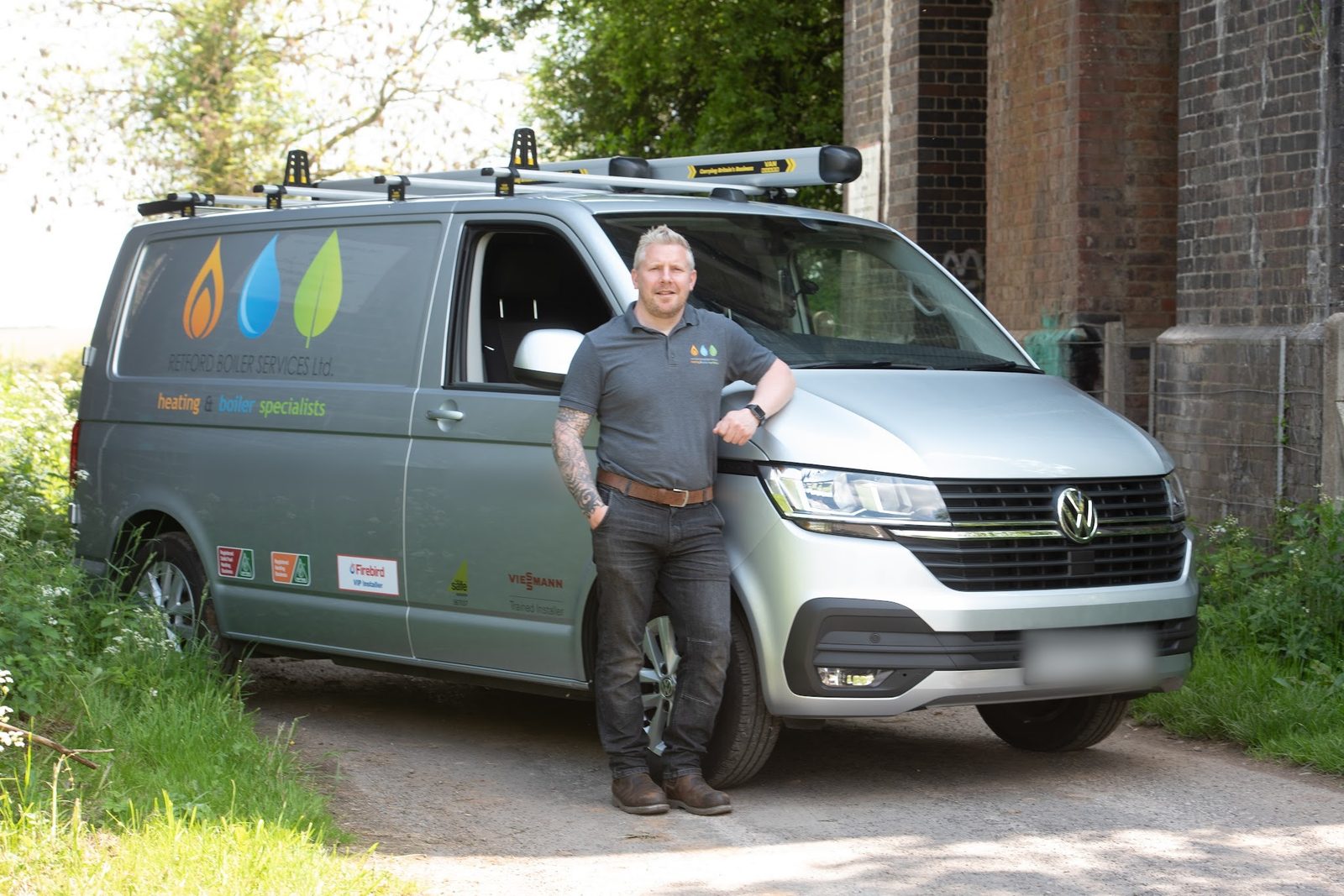James standing beside his liveried VW van